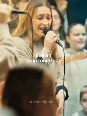 The cover image features a woman with long blonde hair, singing into a microphone. She's wearing a light-colored jacket and is in front of a crowd. Text overlays include "Elohim (Lord our God)" and a username.