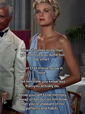 The image is a still from a classic movie, featuring a woman in a blue dress with text overlayed on top. The woman has fair skin, blonde hair, and is looking off to the side with a composed expression. A man in a white suit is partially visible on the left side of the frame. The background is a room with soft lighting and dark shadows.