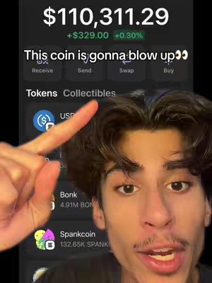 A young man points towards the screen of a crypto app displaying a balance of $110,311.29 and a text overlay. The app shows various crypto tokens.