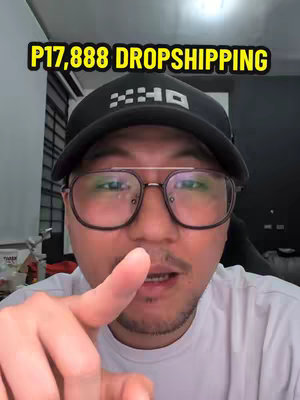 The cover image is a close-up shot of a man with a serious facial expression. The man is wearing a black cap, glasses, and a white shirt. The text overlay on the top is 'P17,888 DROPSHIPPING' in a yellow background. The man is pointing with his index finger at the viewer.