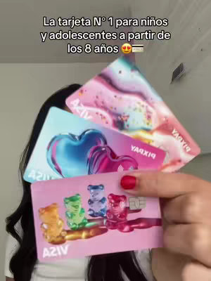 The cover image is a close-up shot of a person's hand holding up three colorful Pixpay cards. The cards have various designs, including heart-shaped visuals and colorful gummy bear illustrations. The person is partially visible.