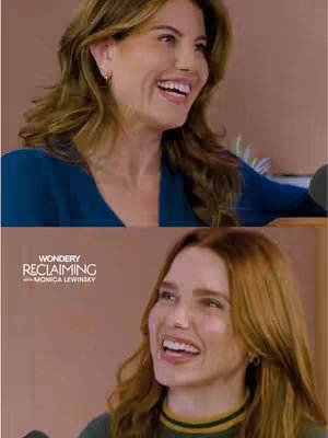 The cover image features two women, each in a close-up shot, smiling and looking towards the viewer. The top portion of the image shows a woman with long blonde hair and a blue top, the background is a light brown. The bottom portion shows a woman with red hair, and a green sweater with a black and yellow collar.
