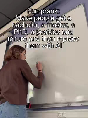 A person wearing glasses and a brown jacket is writing on a white board in front of a window. Text overlays the top portion of the whiteboard.