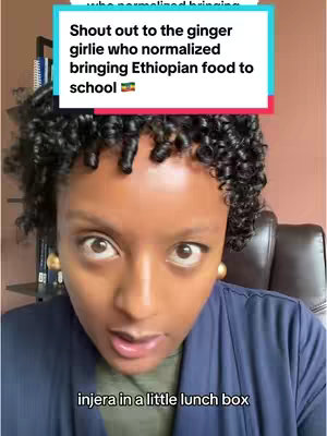 A close-up shot of a woman with dark, tightly curled hair and large gold earrings, looking directly at the camera with wide eyes expressing surprise. A text overlay in a box at the top states, "Shout out to the ginger girlie who normalized bringing Ethiopian food to school." The phrase "injera in a little lunch box" appears in the lower portion of the image.