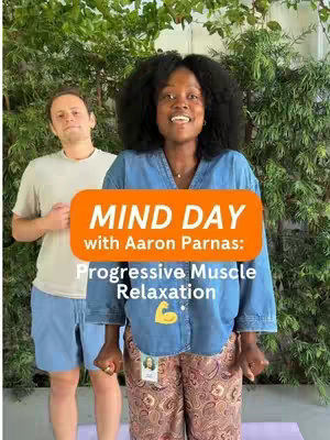 A cover image with two people in front of a green leafy background. An orange rectangle overlaid reads, "MIND DAY with Aaron Parnas: Progressive Muscle Relaxation." The woman in the center is smiling and wearing a denim shirt and patterned pants. The man on the left behind her is wearing a light colored t-shirt and blue shorts. The woman is the primary focus.
