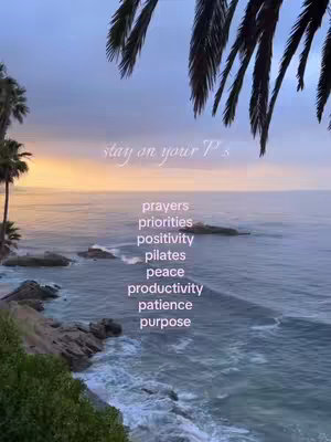 A serene coastal scene at dusk. The sky transitions from a warm orange at the horizon to a pale blue higher up. Palm fronds hang from the top of the frame, with the ocean in the background. The foreground has a rocky shoreline with waves. Text is overlaid on the image with a list of terms.