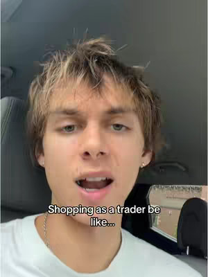 A young man with light brown hair and a white t-shirt is talking in a car. The text overlayed on the image says, "Shopping as a trader be like..."