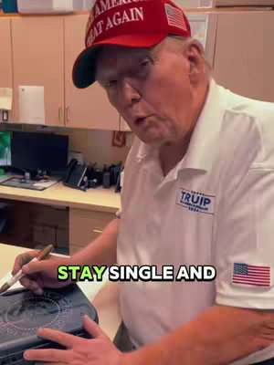 The image features a man in a red cap with 'MAKE AMERICA GREAT AGAIN' on it making a presentation. The hook at the bottom reads, 'STAY SINGLE AND' in a neon green with a black border. The background has wooden cabinets and drawers. An American flag is pinned on the man's shirt.