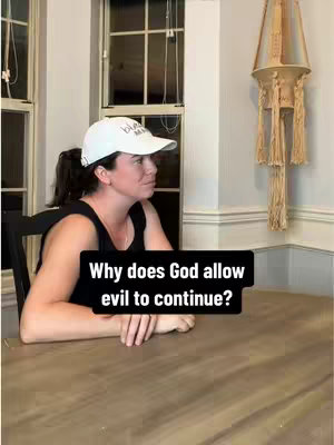 A woman wearing a white baseball cap and black top sits at a wooden table, looking towards the left. A black rectangle overlay contains the text 'Why does God allow evil to continue?' The background includes windows, a decorative hanging element and wall.