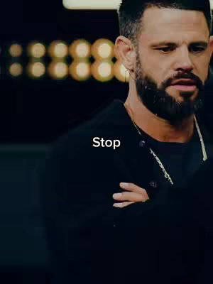A close-up shot of a man, slightly off-center, with a dark background. The man has a beard, short hair, and a necklace. The word "Stop" is overlayed in white text on the image