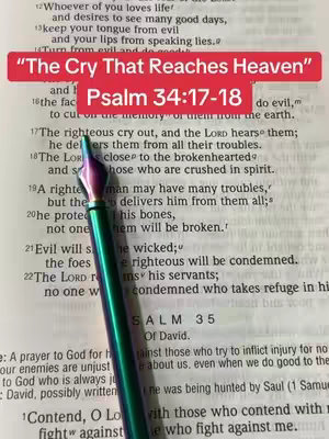 The image shows an open Bible with text and a pen resting on the page. An overlay with red and white text is present at the top. The background is the Bible's pages, showing visible text.