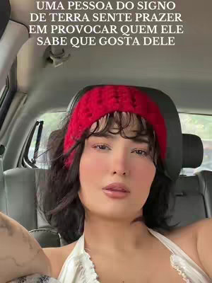 A selfie of a woman inside a car. Her hair is dark with bangs, and she wears a red headband. She gazes at the camera. Text is added to the image at the top.