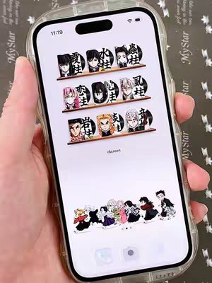 The cover image showcases a smartphone displaying a custom home screen themed around the anime series "Demon Slayer." A hand holds the phone; the screen layout includes character portraits and Japanese text. The overall scheme is clean and visually appealing.