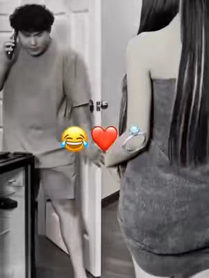 A black and white image with a man on the left talking on a mobile phone, opening a door, and a woman is on the right. Emoticons are added: a laughing face, a red heart, and a ring.