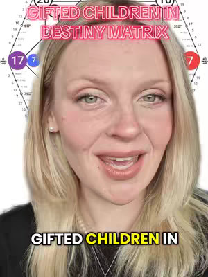 A selfie-style image featuring a fair-skinned woman with blonde hair. She has a bright, open expression. Above her head, overlaid text states "GIFTED CHILDREN IN DESTINY MATRIX". A background element resembling a diagram with astrological symbols and numbers is partially visible. The overall composition is well-lit and focused on the subject.