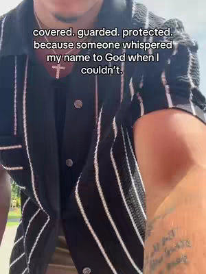 The image shows a person from the chest up, wearing a shirt with black and white stripes and a cross necklace. Text overlays the image in a clear, easy-to-read font.