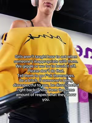 A woman in a yellow sweatshirt and headphones is centered in the frame from the chest up. Text on the image provides the content of the video. The background is blurred, showing an out-of-focus environment.