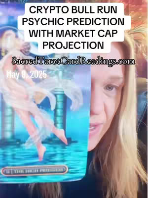 The cover image features a woman on the right side, slightly angled towards the center. She is holding a tarot card that's partially visible, taking up the left side of the image. Above her, text overlays read "CRYPTO BULL RUN PSYCHIC PREDICTION WITH MARKET CAP PROJECTION" and "SacredTarotCardReadings.com" with the date of "May 9, 2025" visible.