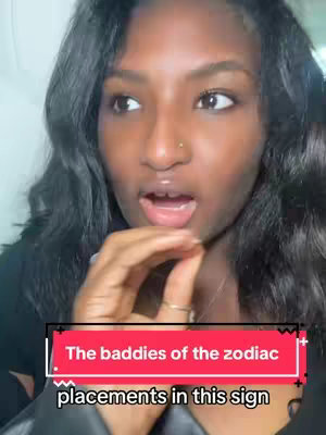 A woman with long, wavy black hair is looking off to the side with a surprised expression. Her mouth is slightly open, and her hand is raised near her mouth. A text overlay at the bottom of the image reads \"The baddies of the zodiac\" displayed within a red background.
