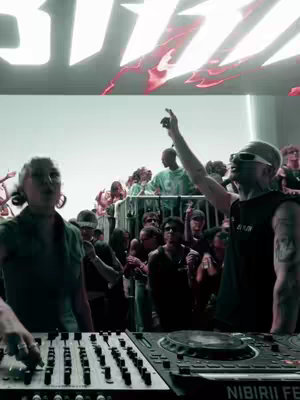 The cover image shows a live music event, with a DJ on the left, and another person raising their arm on the right side. The background is filled with a crowd, and a 'BIZZ' text is present above. The lighting is set to a green undertone to showcase a party atmosphere at night. 