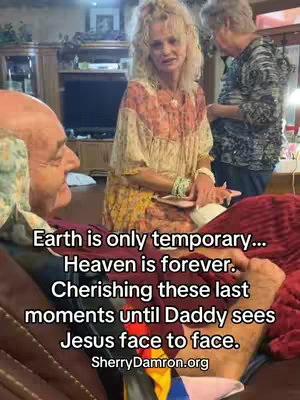 The cover image features a living room setting with a man lying in bed speaking, while a woman stands nearby, seemingly comforting him. The man is mostly bald, with a multi-colored shirt; the woman is wearing a floral patterned dress. Another person is standing behind them. Text overlay adds context.