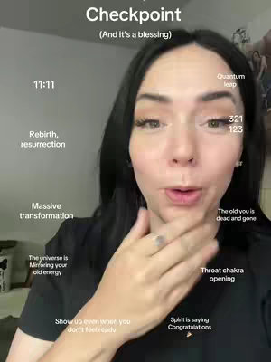 A woman with black hair looks directly at the camera, holding her right hand near her face. Text overlays with spiritual or motivational messages are scattered around her face.