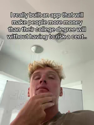 A selfie-style video with a young man. The man has light skin and short, spiky, blonde hair. He is positioned at the bottom center and is wearing a casual t-shirt. He looks up, eyes closed, and is touching his lower face with one hand. The primary background is a white wall, and there is text overlaid at the top.