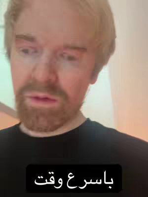 A man with light hair and some beard looks at the camera with concern. Text in a black box is at the bottom of the frame.