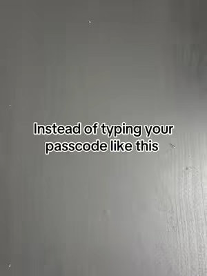 The image shows a close-up view of a flat gray surface. Centered on the surface, text is overlaid in a sans-serif font. The text reads, \"Instead of typing your passcode like this\". The text is positioned and styled to convey the specific message about iPhone passcodes.