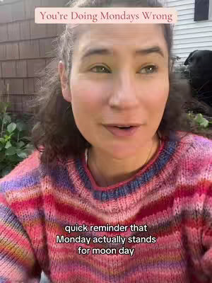 A woman with fair skin and dark, wavy hair is shown against a slightly blurred outdoor background. She is wearing a pink and multi-colored striped sweater. Above her in a pink rectangle, text says, "You're Doing Mondays Wrong." Further down, overlaid text reads, "quick reminder that Monday actually stands for moon day".