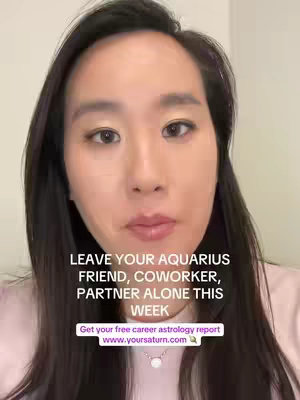 A selfie-style video cover featuring a light-skinned Asian woman with long, dark hair. She occupies most of the frame, with a light pink top. Overlayed text in white font on the lower portion of the frame reads, "LEAVE YOUR AQUARIUS FRIEND, COWORKER, PARTNER ALONE THIS WEEK." Below this, in a smaller, rectangular box is the text Get your free career astrology report www.yoursaturn.com. The woman has a neutral expression, looking straight at the camera.