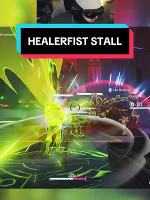 The cover image shows a gaming scene with a first-person perspective. A character wearing a headset is visible in the top portion of the image. The bottom portion depicts a fast-paced action sequence with green and yellow energy effects, featuring a person fighting in a virtual environment, with health bars and other game-related data displayed.