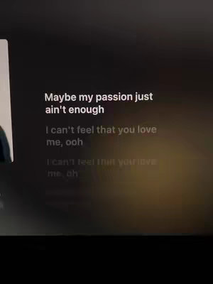 The cover image displays song lyrics. Text overlays on a black background with color gradients. The lyrics include a line about passion not being enough.