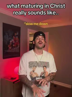 A man in a white t-shirt and black cap stands in a room, speaking. Text overlays include a title: 'what maturing in Christ really sounds like..' and 'slow me down'. In the background is a framed image and dim lighting.