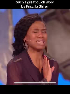 The cover image shows a medium shot of a woman with dark skin and curly hair, her eyes closed. She has a small microphone clipped to her collar. In the background, the lighting shows a bright blue color. The woman has her hand on her chest, and her expression suggests emotion.