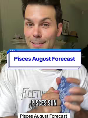 A man with short dark hair smiles directly at the camera. He wears a white t-shirt and holds a deck of cards, slightly out of focus. Overlaid on the image is a blue and white banner with the text 'Pisces August Forecast.' Below the banner, the words 'PISCES SUN' are visible. The background suggests an indoor setting with a green wall and a partially visible ornate detail on a white cabinet.