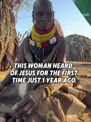 A woman with traditional African adornments, including colorful beaded necklaces, sits outdoors. The background shows a rustic setting with trees and a traditional hut, indicating a rural environment. The text overlay highlights a significant fact about her.
