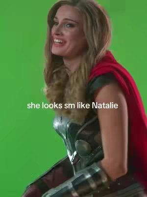 A woman in costume smiling, in front of a green screen. Text overlay says 'she looks sm like Natalie'.