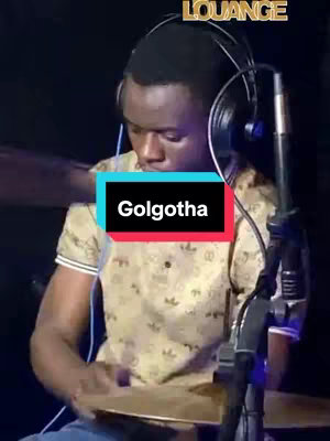 The image shows a man playing drums in a studio setting. He is wearing headphones and a patterned shirt. Text overlay reads the word "Golgotha" with a black background and white text.