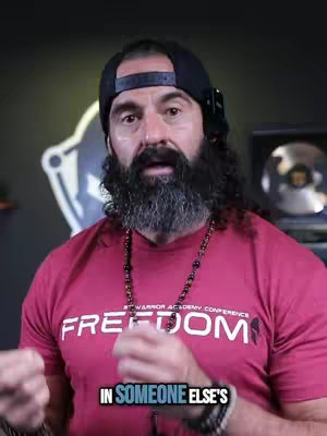 The cover image shows a man with a full black beard and a dark hat turned slightly to the side.  He is wearing a red t-shirt that says "FREEDOM" on it, and he has a dark necklace. At the bottom of the image is overlaid text.