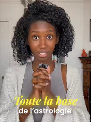 The cover image features a woman with dark curly hair in front of a bright background. She is holding an object close to her chest with a focused expression, centered in the frame. Text overlayed below the woman reads, "Toute la base de l'astrologie."