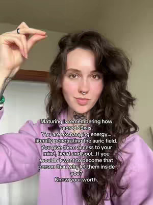 A woman in a mauve hoodie is making a hand gesture. Text is overlaid on the image which contains a message about s3x and energy exchange.