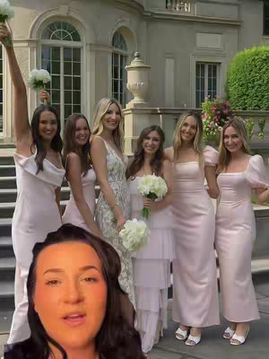 A cover image featuring a woman with dark hair and a warm complexion in the bottom foreground, looking upwards and to the side with a soft smile. Behind her, a group of six women stand on steps in front of a large, classical-style building. The women in the background are wearing matching light pink dresses and holding bouquets, implying they are bridesmaids. The setting appears to be an outdoor wedding.