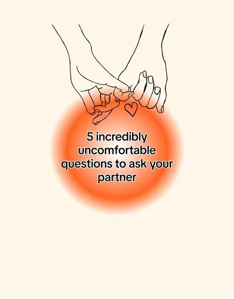 An image with a light beige background. Two hands are shown intertwined at their pinky fingers with a line art style. A small heart is drawn between the clasped fingers. A bright orange, slightly blurred circle is centered below the hands. Within the orange circle, the text reads: "5 incredibly uncomfortable questions to ask your partner". The overall composition uses a simple design to highlight its central elements.