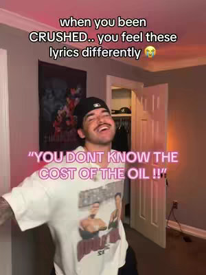 The cover image shows a man smiling and looking upwards in a room. Text is overlaid on the image, including lyrics. The man is positioned in the center and wearing a t-shirt showing a print.
