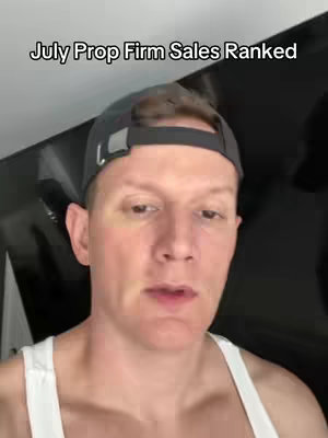 A man with fair skin and short, slicked-back red hair is the central focus of the image. He wears a dark gray baseball cap and a white tank top. The background is a dark, slightly blurred setting. The upper part of his face is visible, looking towards the viewer, presenting the video's hook.