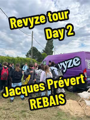 A group of teenagers in a school setting, walking towards a purple van. The van has the word "vyze" on it. In the sky, there are clouds.