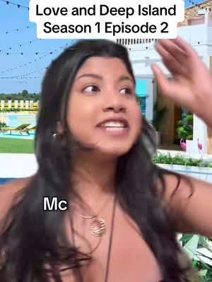 The image is a selfie-style shot featuring a woman with long, dark hair and a slightly surprised expression. She's wearing a necklace and appears to be in a tropical setting, with a pool and a villa visible in the background. Text overlays are at the top and bottom-left of the frame, indicating the show's title and a character designation.