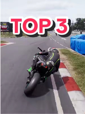 The cover image shows a motorcycle racer leaning into a turn on a racetrack. The racer is wearing a black and green racing suit. The words 'TOP 3' are visible in a red and white text overlay. The background includes the track, a gray sky, and some blue barriers.