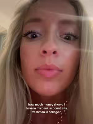 A close-up selfie shows a young woman with blonde hair. She has large eyes, full lips, and a fair complexion. Her expression is one of slight concern or questioning, and the text overlay asks a question about money.